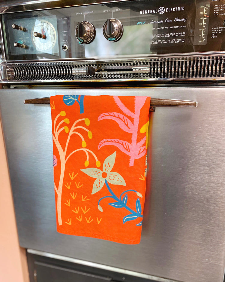 poppy red kitchen towel hanging on vintage oven